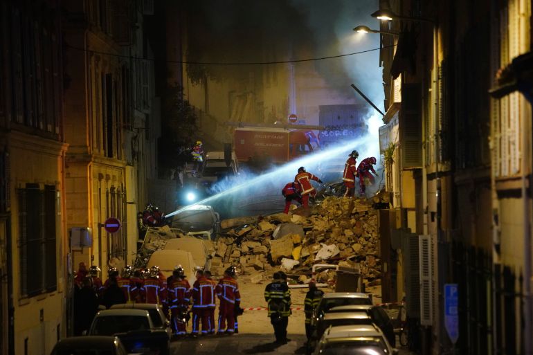 Firefighters work after building collapsed early Sunday, April 9, 2023 in Marseille, southern France. A residential building in France's port city of Marseille collapsed in a loud explosion early Sunday followed by a fire deep within the rubble that hindered rescue efforts. (AP Photo)