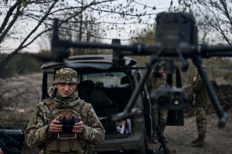 A Ukrainian soldier launches a drone in the area of the heaviest battles with Russian troops in Bakhmut, Donetsk region, Ukraine, Sunday, April 9, 2023. (AP Photo/Libkos)