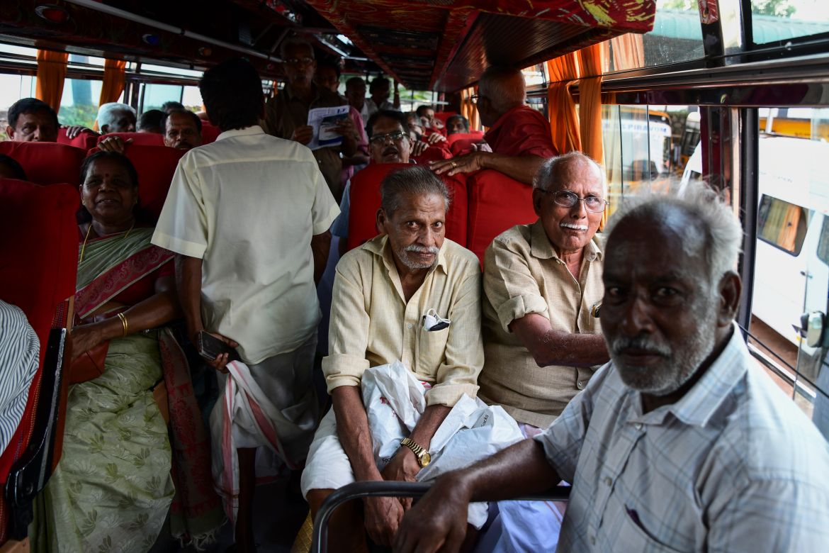 Pensioners leave in a bus after their meeting in Piravom, Kerala state