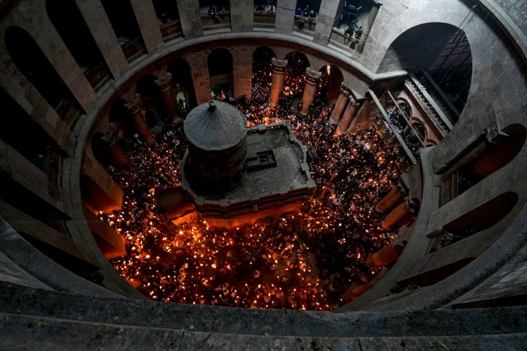 Christian pilgrims hold candles as they gather during the ceremony of the Holy Fire at Church of the Holy Sepulchre in Jerusalem.