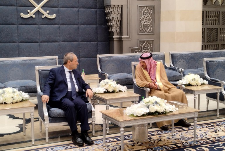 Saudi Deputy Foreign Minister Waleed Al-Khuraiji, right, meets with Syrian Foreign Minister Faisal Mekdad, upon his arrival at King Abdulaziz International Airport, in Jeddah, Saudi Arabia.