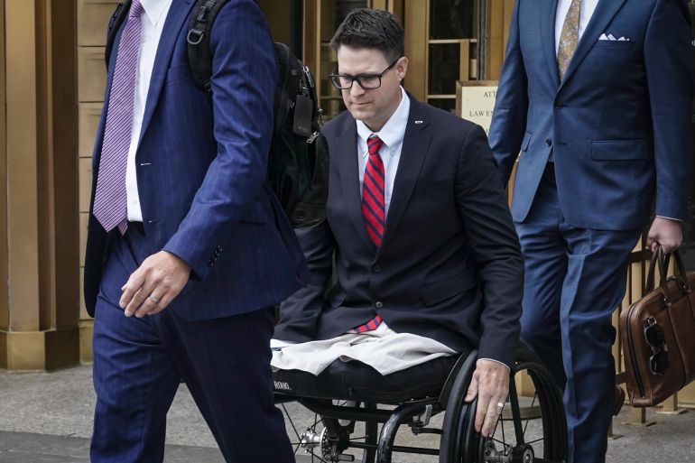 A man in a wheelchair leaves a courthouse in New York