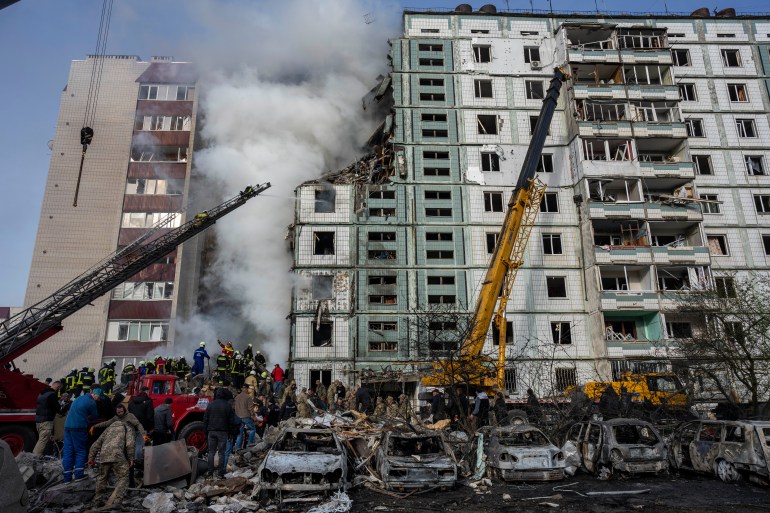 Firefighters work to extinguish a fire after a Russian attack at a residential building in Uman, central Ukraine, Friday, April 28, 2023. (AP Photo/Bernat Armangue)