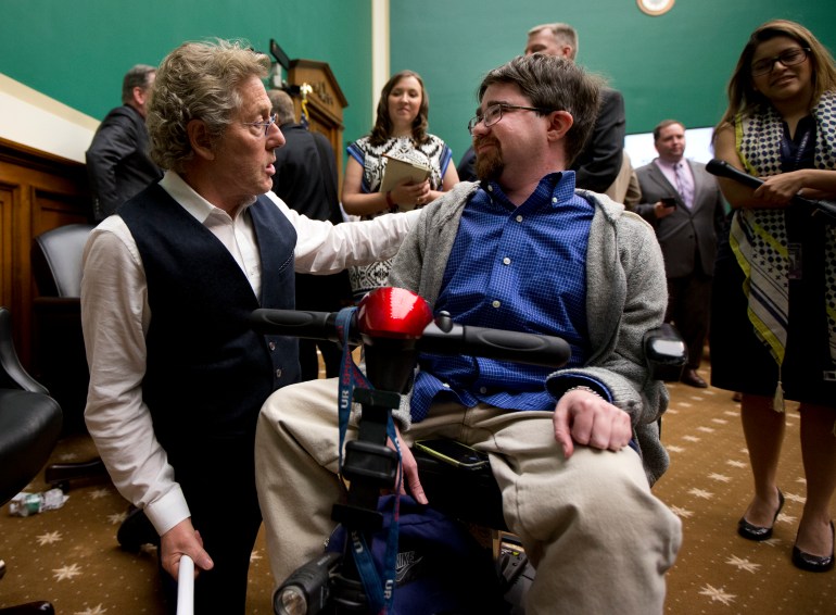 Roger Daltrey, lead singer of the English rock band "The Who" and co-founder of Teen Cancer America, talks to Buddy Cassidy, right, from Annandale, Va., on Capitol Hill in Washington, Wednesday, March 23, 2016, at the conclusion of a conversation on child cures hosted by the House Energy and Commerce Committee. Cassidy, 26, who suffers from duchenne muscular dystrophy, was invited by Daltrey to his concert as his guest. (AP Photo/Manuel Balce Ceneta)