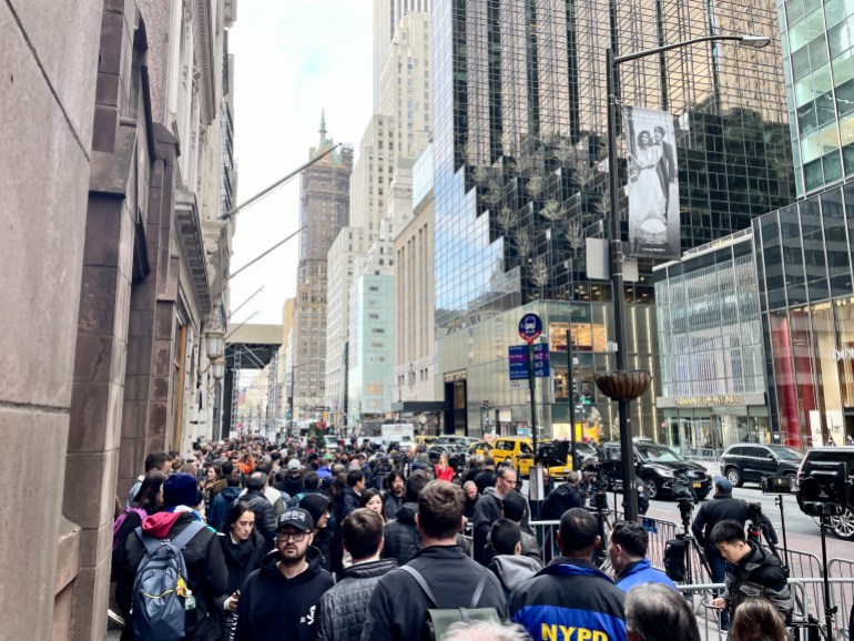 A busy street in front of Trump Tower