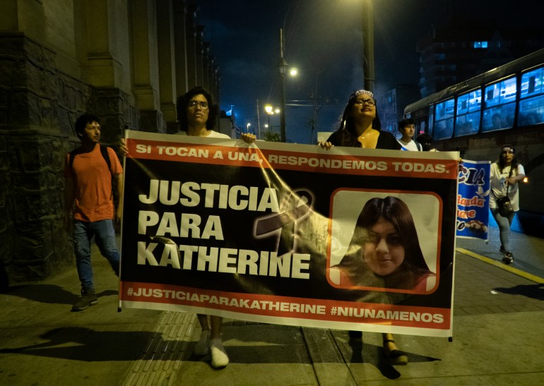 Protesters on the street carry a banner with the text "Justice for Katherine"