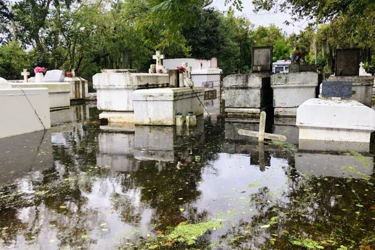 A photo of flooded gravestones and tombstones.