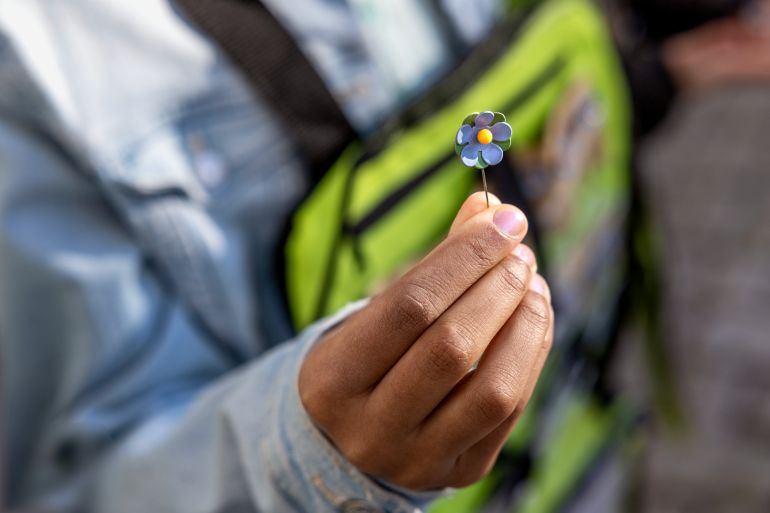 Boy in Sweden raises money selling flower pins
