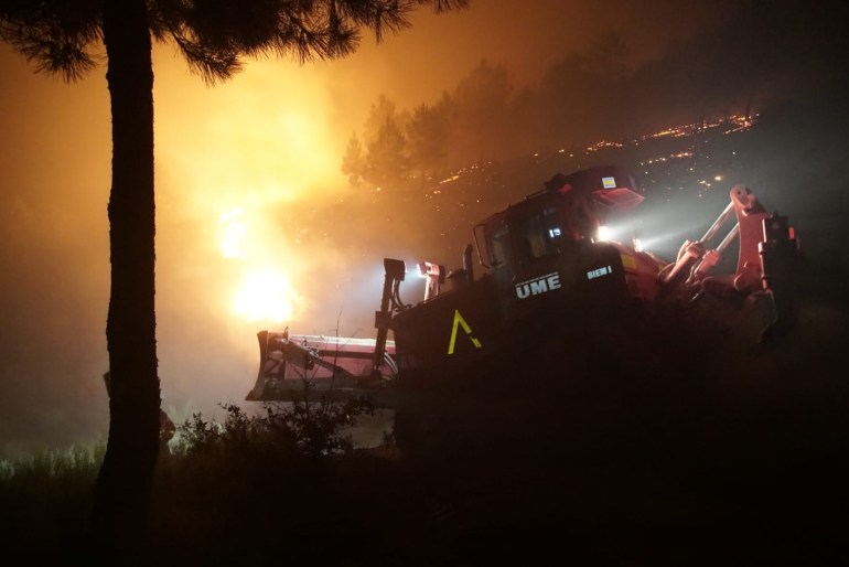 A handout photo made available by Spanish Defense Ministry shows firefighters trying to extisguish a fire at the villages of Cadalso, Descargamaria and Robledillo de Gata, in the area of Sierra de Gata, Caceres, Extremadura, Spain, 18 May 2023. About 550 persons have been evacuated. 
