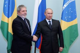 Brazil's President Luiz Ignacio Lula da Silva (L) shakes hands with Russia's Prime Minister Vladimir Putin as they meet in Moscow May 14, 2010. Brazilian President Luiz Inacio da Lula Silva vowed on Friday to do his best on a forthcoming visit to Tehran to persuade Iran of the need for dialogue over its nuclear programme. REUTERS/Ria Novosti/Pool/Alexei Druzhinin (RUSSIA - Tags: POLITICS)