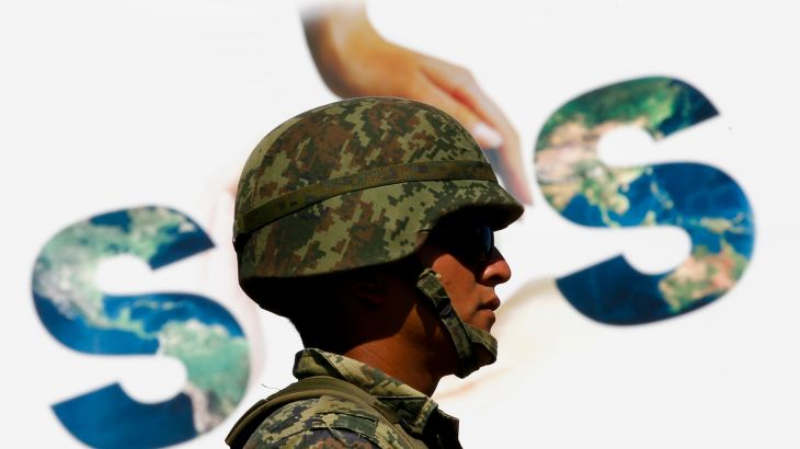 A soldier guards the venue of U.N. climate talks in Cancun December 10, 2010.