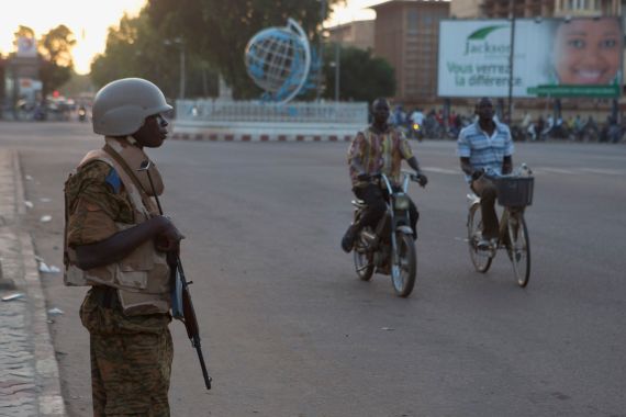 A soldier stands guard outside a building where a meeting between the military and opposition was taking place in Ouagadougou, capital of Burkina Faso, November 2, 2014. Burkina Faso's army cleared thousands of protesters from the capital and fired warning shots at state TV headquarters on Sunday as it sought to tighten its grip on power following the resignation of President Blaise Compaore two days ago. REUTERS/Joe Penney (BURKINA FASO - Tags: POLITICS CIVIL UNREST MILITARY)