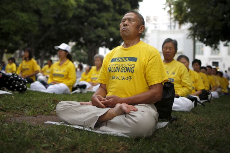 People practice Falun Dafa, or Falun Gong, meditation and exercises before a protest march against the Chinese government, outside City Hall in Los Angeles, California October 15, 2015. REUTERS/Lucy Nicholson