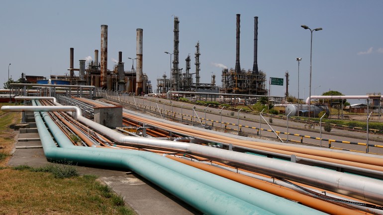 Multicolored oil pipes lead to a refinery