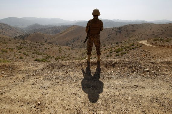 A Pakistani soldier stands guard outside an outpost along the border fence on the border with Afghanistan in North Waziristan.
