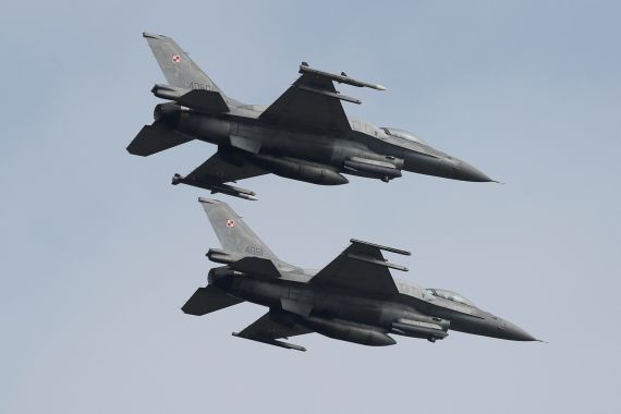 Polish Air Force F-16 fighter jets fly in formation during a military drills at Starokostiantyniv Air Base in in Ukraine