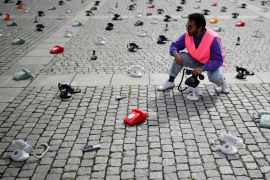 A man sets two of around 300 landline telephones placed by Syrian families at the Bebelplatz as a call to governments to do more to seek information about detained people in Syria, in Berlin, Germany August 28, 2021. REUTERS/Hannibal Hanschke