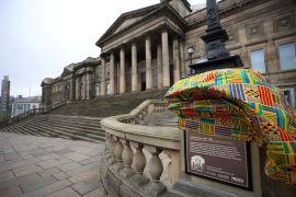 Traditional African Kente Cloth covers a newly installed plaque, explaining the links to the street name and the slave trade is seen outside the World Museum in Liverpool, Britain, April 5, 2022.