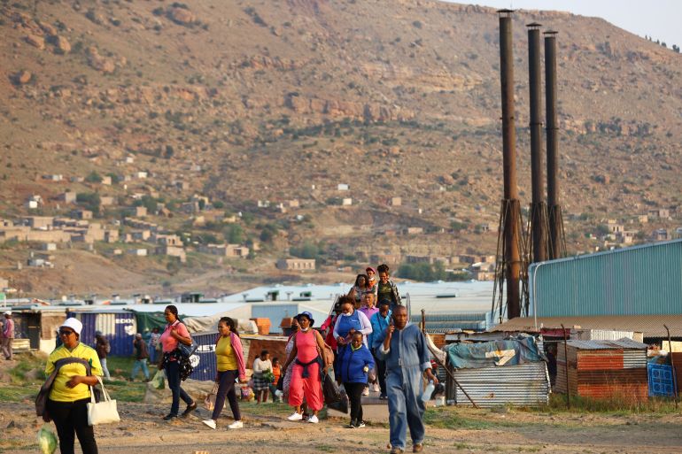 Factory workers walk home after work, ahead of the general elections, outside the capital Maseru in Lesotho, October 6, 2022.REUTERS/Siphiwe Sibeko