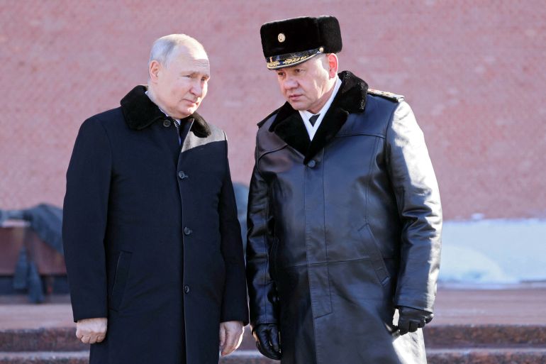Russian President Vladimir Putin and Defence Minister Sergei Shoigu take part in a wreath laying ceremony at the Tomb of the Unknown Soldier by the Kremlin Wall on the Defender of the Fatherland Day in Moscow, Russia, February 23, 2023. Sputnik/Mikhail Metzel/Pool via REUTERS ATTENTION EDITORS - THIS IMAGE WAS PROVIDED BY A THIRD PARTY.
