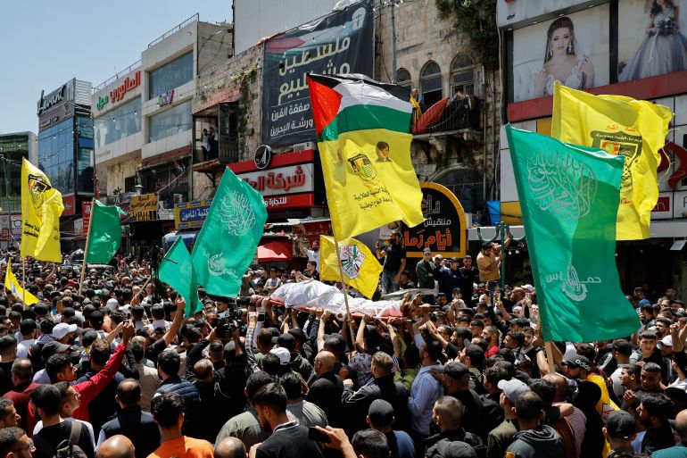 Mourners carry the body of a Palestinian gunman who was killed by Israeli forces in a raid, during a funeral in Nablus in the Israeli-occupied West Bank