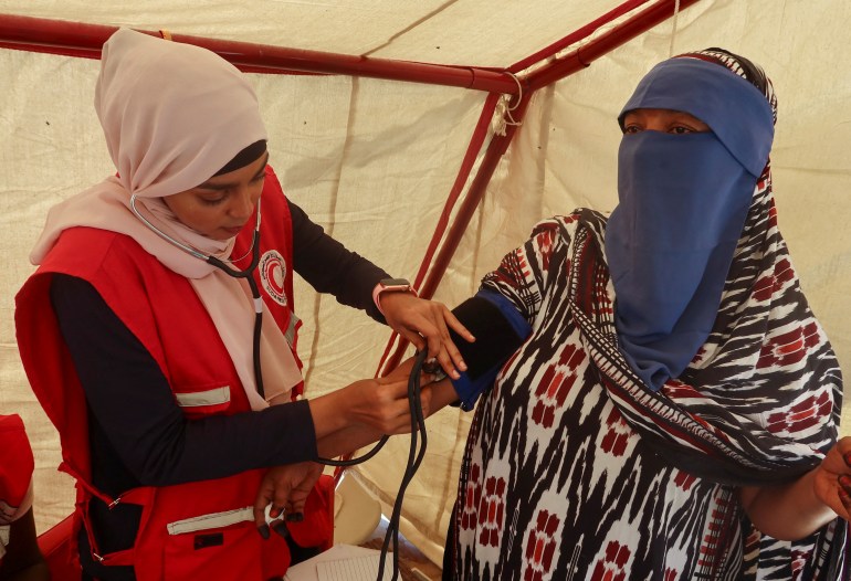 A woman receives medical attention inside the Sundanese Red Crescent tent in Port Sudan, Sudan.