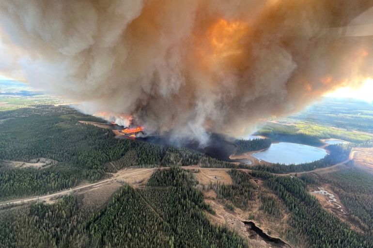 A smoke column rises from wildfire EWF031 near Lodgepole, Alberta, Canada