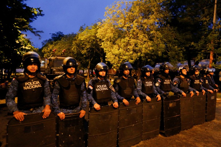 A line of police in riot gear