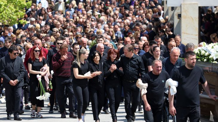 People attend a funeral for the murdered security guard, following a school mass shooting, after a boy opened fire on others, killing fellow students and staff