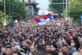 A sea of people at the 'Serbia against Violence' protest in Belgrade. A group in the middle is holding a Serbian flag aloft