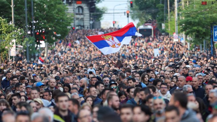 A sea of people at the 'Serbia against Violence' protest in Belgrade. A group in the middle is holding a Serbian flag aloft