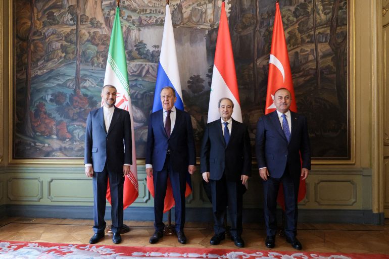 Foreign ministers Hossein Amirabdollahian of Iran, Sergei Lavrov of Russia, Faisal Mekdad of Syria and Mevlut Cavusoglu of Turkey pose for a picture during a meeting in Moscow