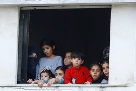 Children look out of the window in the southern Gaza Strip, amidst an Israeli assault on the besieged coastal enclave.