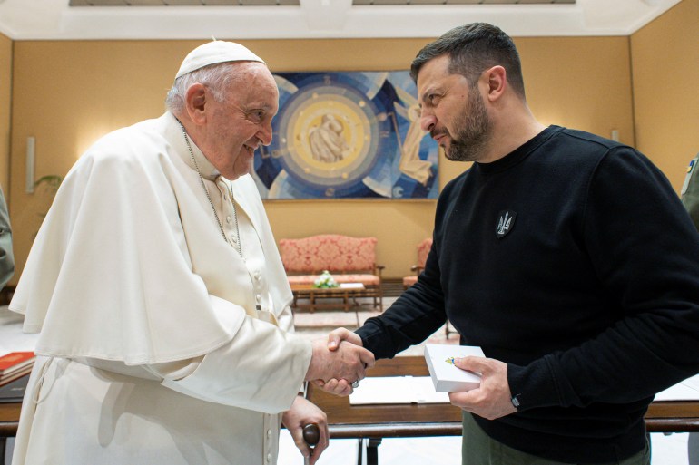 Pope Francis shakes hands with Ukrainian President Volodymyr Zelenskiy, at the Vatican, May 13, 2023. 