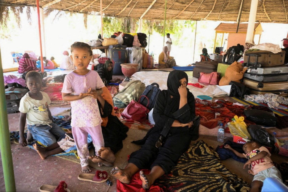 Sudanese people rest at a camp center next to Coral Garden Hotel as they call for evacuation to safe countries