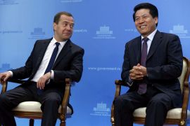 Li Hui sitting next to then Russian Prime Minister Dmitry Medvedev in Moscow, Russia, June 29, 2015.