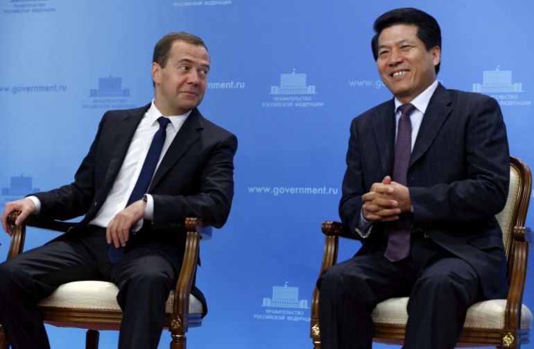 Li Hui sitting next to then Russian Prime Minister Dmitry Medvedev in Moscow, Russia, June 29, 2015.