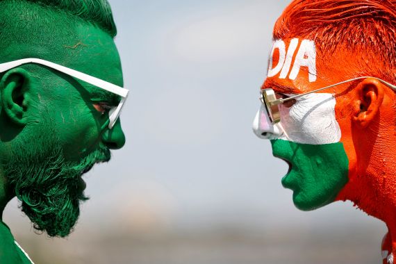 Cricket fans with their faces painted in the Indian and Pakistani national flag colours