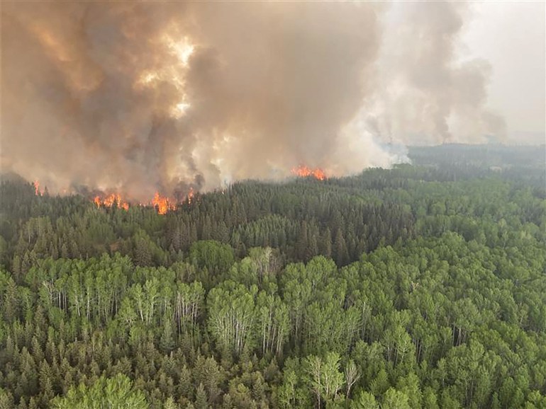 Smoke rises from a wildfire in Alberta, Canada.