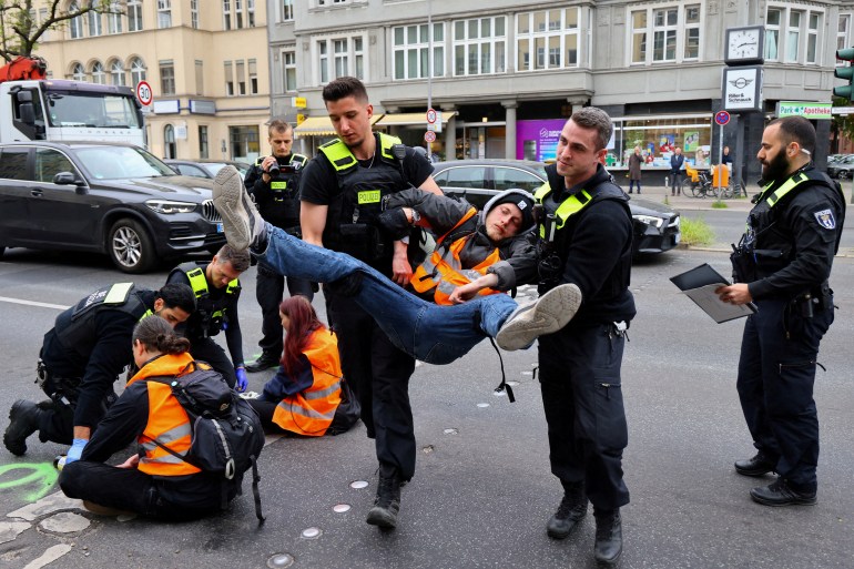 Police officers take an activist to "last generation" (Last Generation) who previously stuck to a street in the Steglitz district to protest against climate advice, speed limits on motorways as well as accessible public transport, in Berlin, Germany, 16 May 2023.