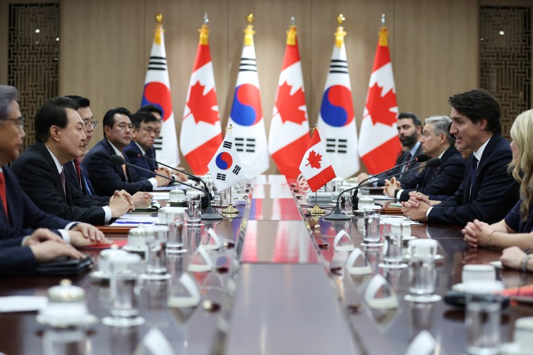 Canada’s Prime Minister Justin Trudeau talks with South Korea’s President Yoon Suk Yeol during their meeting at the Presidential Office in Seoul, South Korea, 