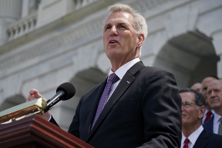 Kevin McCarthy, standing with a loudspeaker near an outdoor podium, speaks to reporters outside the US Capitol on May 17.