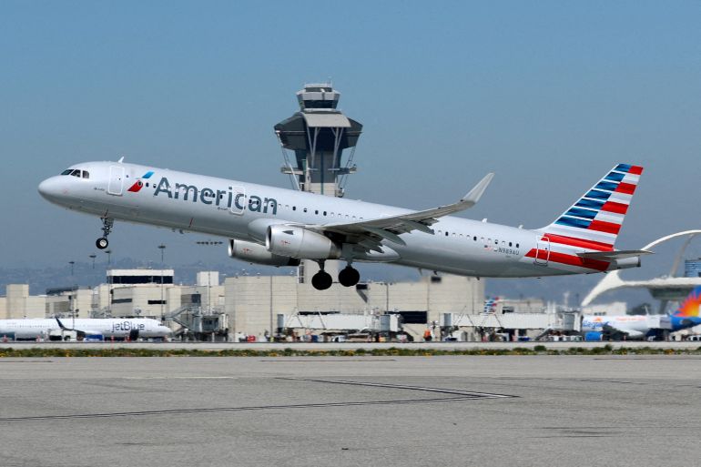 An American Airlines flight takes off on a runway.