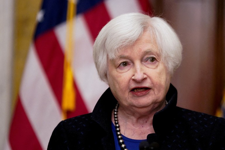A close-up of Janet Yellen against an American flag.