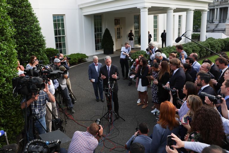 US House Speaker Kevin McCarthy speaks to reporters outside the West Wing of the White House with Representative Patrick McHenry behind him.