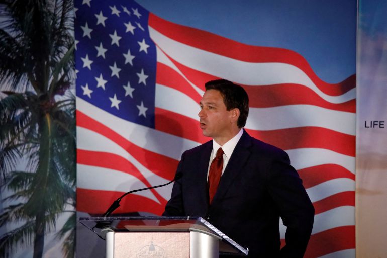 DeSantis at a podium in front of a stylised US flag