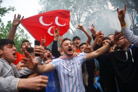 Supporters of Turkish President Recep Tayyip Erdogan react to election results outside the provincial headquarters of Erdogan&#39;s AK Party in Istanbul. [Hannah McKay/Reuters]