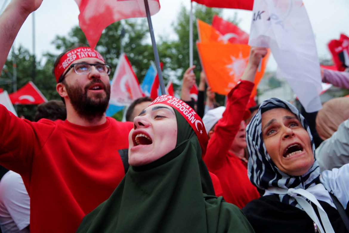 Supporters of Turkish President Tayyip Erdogan react following early exit poll results