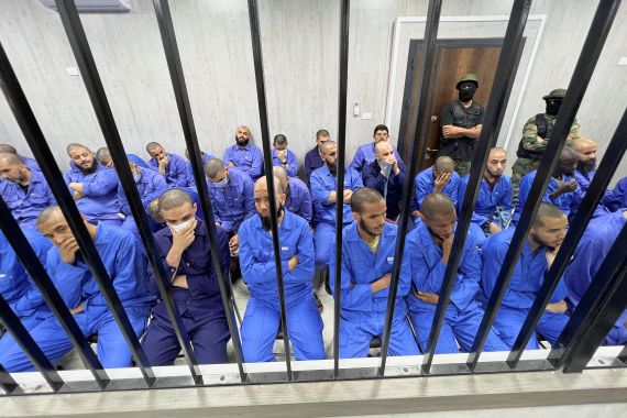 Suspects sit behind bars during a judgment sentence against 56 defendants accused of joining Islamic State group (ISIS) in the court in Misrata, Libya, May 29, 2023. REUTERS/Ayman al-Sahili