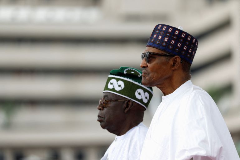 Nigeria's President Bola Tinubu stands next to his predecessor Muhammadu Buhari during his swearing-in ceremony in Abuja.